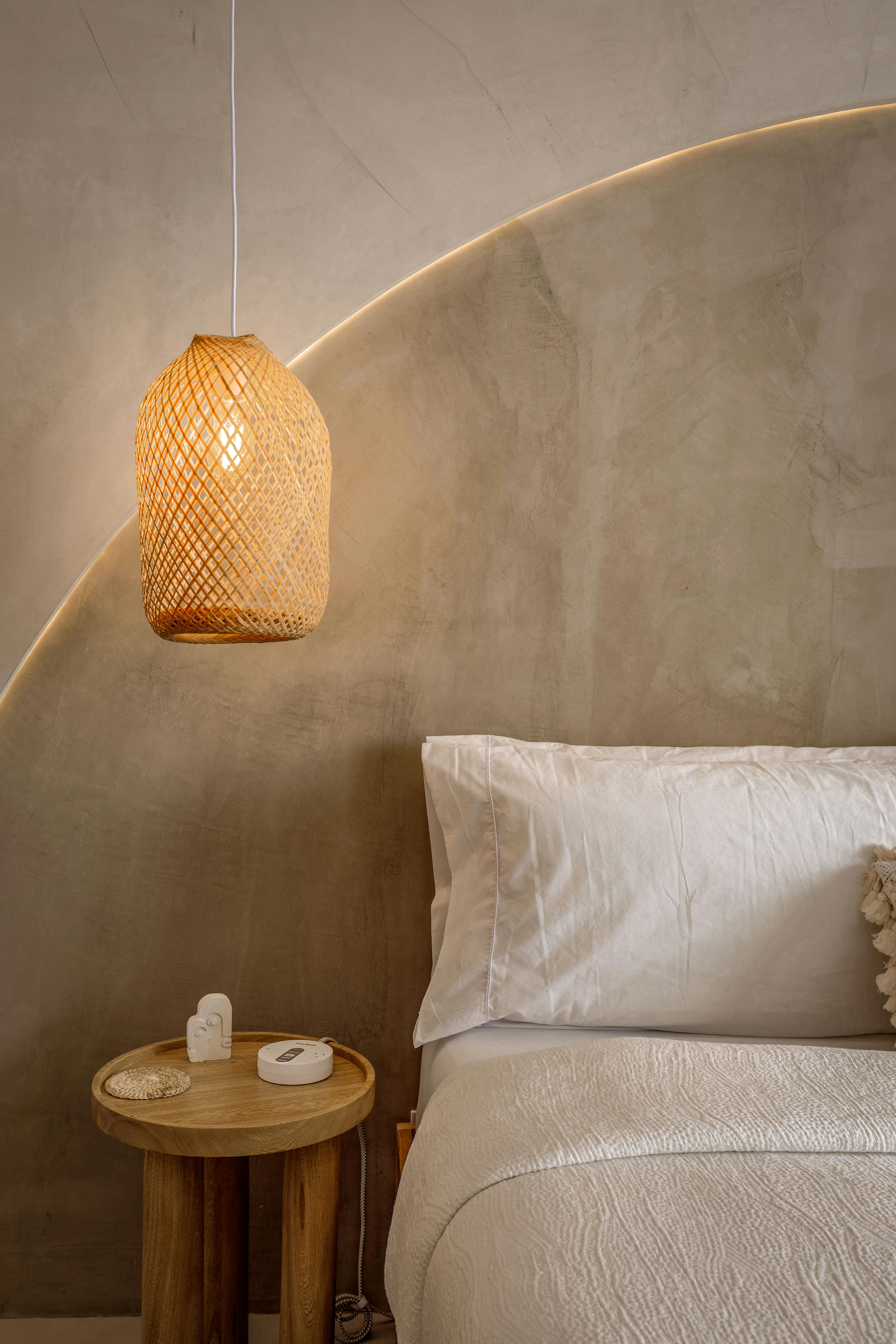 Cozy bedroom with woven pendant lamp at Otium rental
